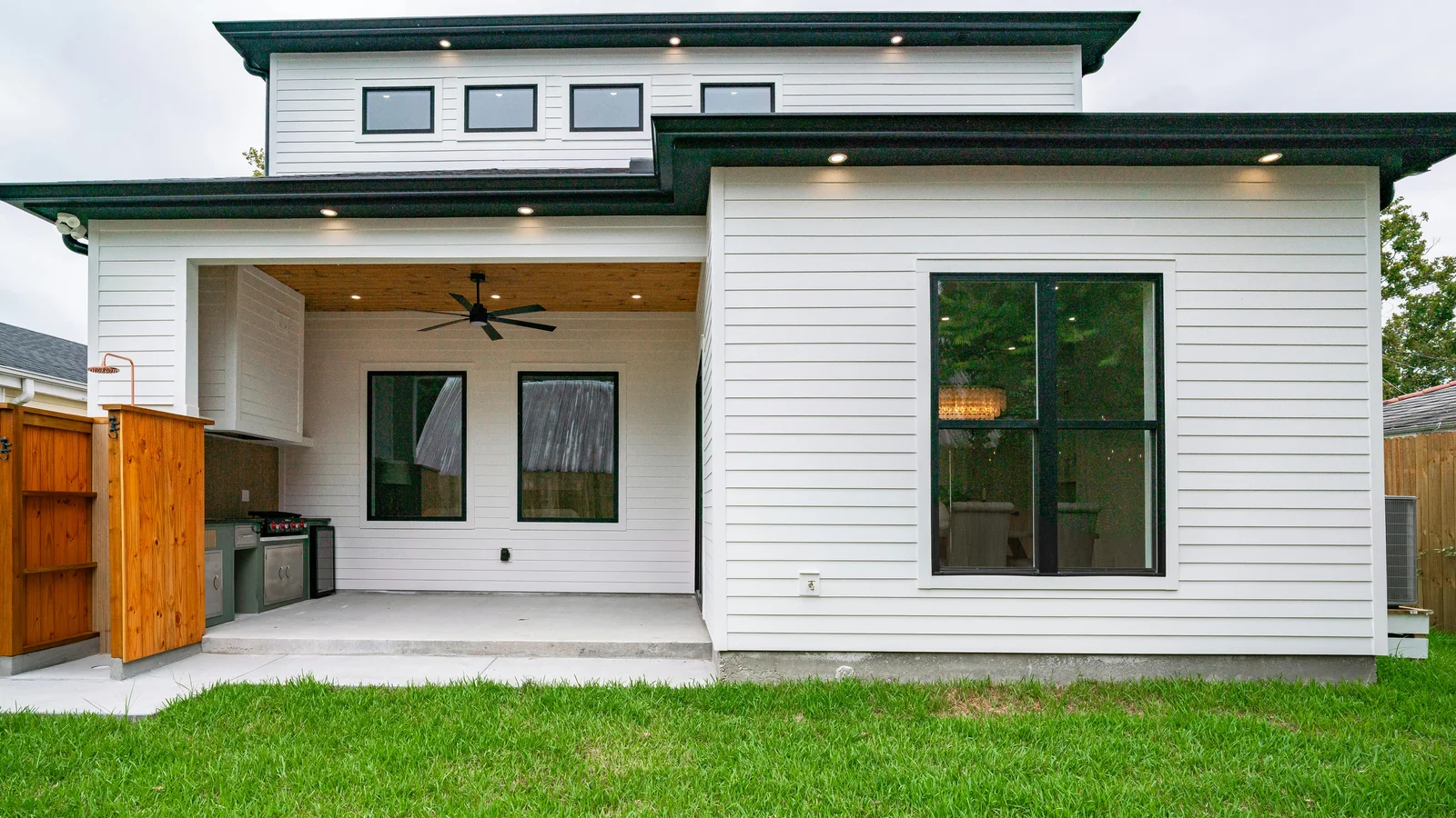A sleek modern backyard patio with clean architectural lines, framing the kind of outdoor living scene where a buyer wants to see the structure on screen before they commit to the build.