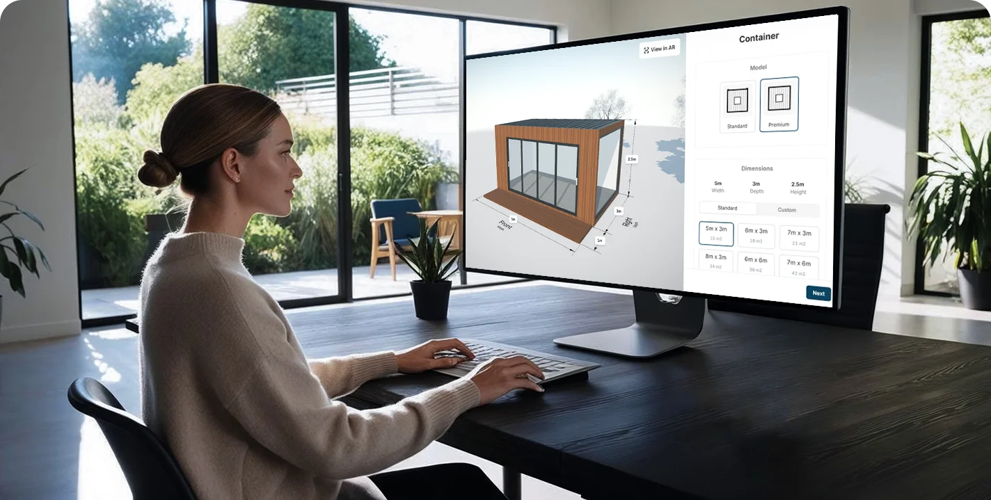 A buyer at home designing a garden room on a desktop configurator.